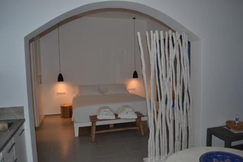 a bedroom with a bed and a table with two lamps at Nautilus Apartments in Lipsoi