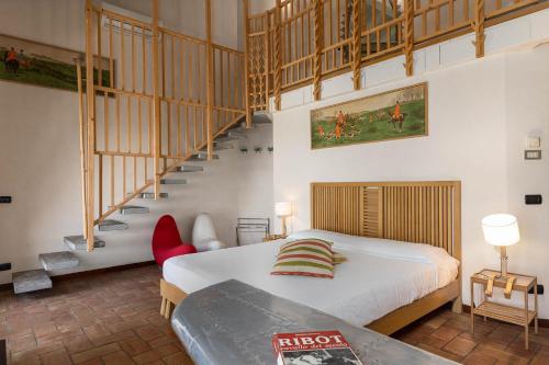 a bedroom with a bed and a staircase in it at La Cucchetta in Dormelletto