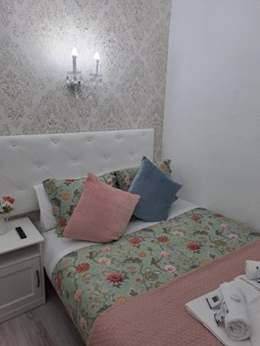 a bed with pillows on it in a room at Hostal Milan in Madrid