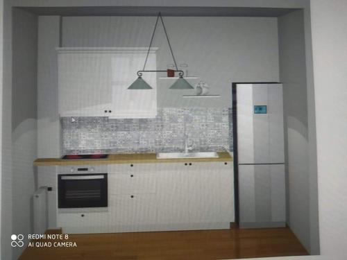 a kitchen with a counter and a refrigerator at Sea View Stone House in Naousa