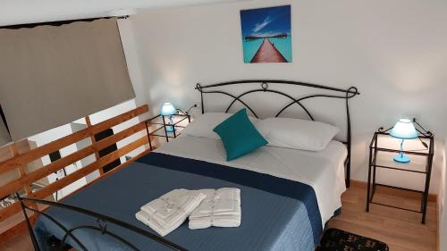 a bedroom with a bed with two slippers on it at Home & Bed Spartano in Sapri