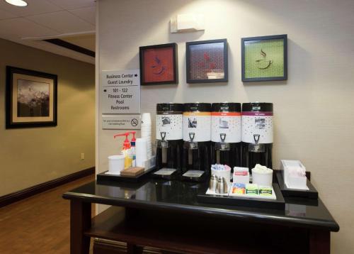 a table with a bunch of products on it at Hampton Inn North Brunswick NJ in North Brunswick
