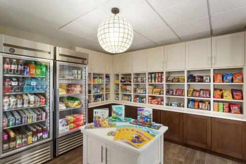 a room with a refrigerator and a counter with food at Homewood Suites by Hilton Fargo in Fargo