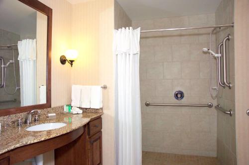 a bathroom with a shower and a sink at Homewood Suites by Hilton Fargo in Fargo
