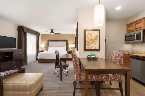 a hotel room with a bed and a desk at Homewood Suites by Hilton Fargo in Fargo