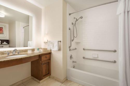 a bathroom with a shower and a sink at Homewood Suites by Hilton Fargo in Fargo