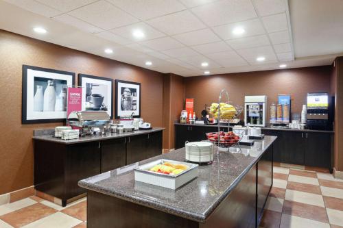 a restaurant with a counter with fruit on it at Hampton Inn & Suites Fresno - Northwest in Herndon