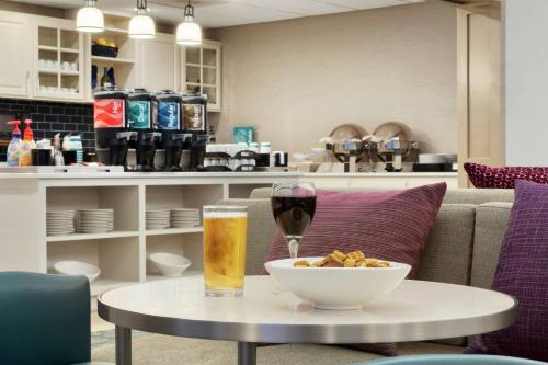 a table with a bowl of food and a glass of wine at Homewood Suites by Hilton Fargo in Fargo