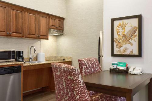 a kitchen with a table and chairs in a kitchen at Homewood Suites by Hilton Fargo in Fargo