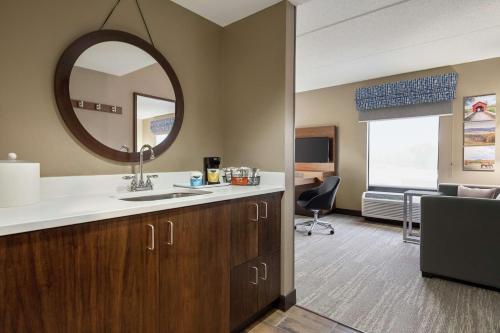 a bathroom with a sink and a mirror at Hampton Inn & Suites Frederick/Fort Detrick in Frederick