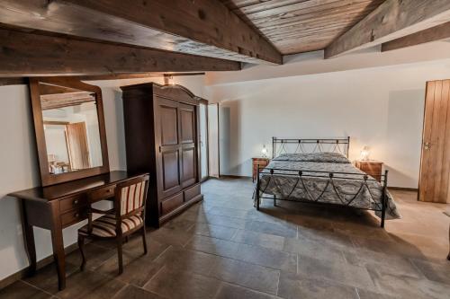 a bedroom with a bed and a dresser and a desk at Agri Charme Tenuta Picilli in Albanella