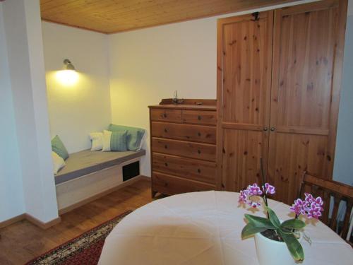 a bedroom with a bed and a dresser and a table at Haus Erle in Peiting