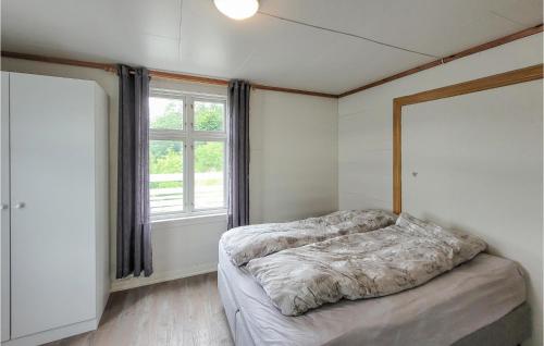 a bedroom with a bed and a large window at Stunning Home In ystese With Wifi And 4 Bedrooms in Øystese