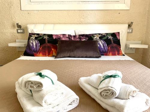 a bed with towels on top of it at Residenza Donna Peppina in Tropea