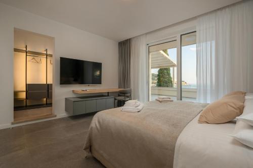 a bedroom with a large bed and a television at Levanat in Dubrovnik