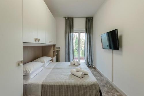 a bedroom with a bed with two towels on it at RESIDENZA ERES EUR in Rome