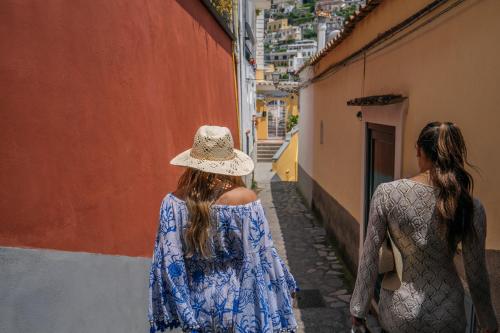 two women walking down a narrow alley at Albergo Miramare Positano in Positano