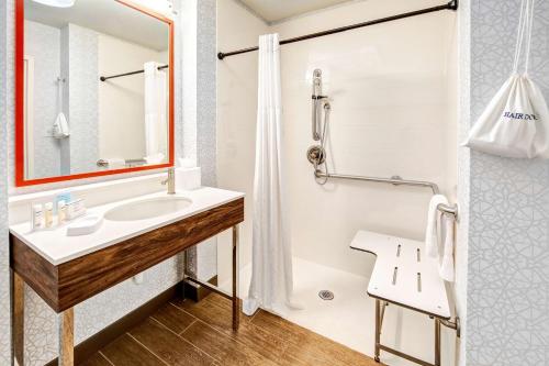 a bathroom with a sink and a shower at Hampton Inn Van Buren in Van Buren