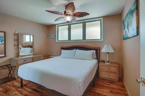 a bedroom with a bed and a ceiling fan at Kaunakakai Condo with Private Lanai and Ocean Views! in Kaunakakai