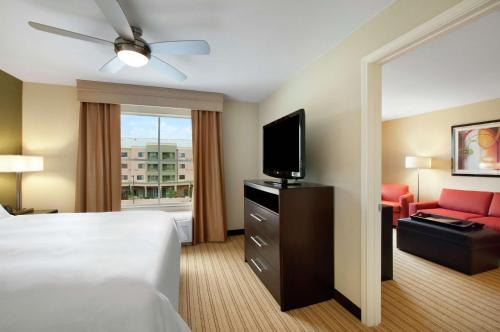 a hotel room with a bed and a flat screen tv at Homewood Suites by Hilton Fort Worth West at Cityview in Fort Worth