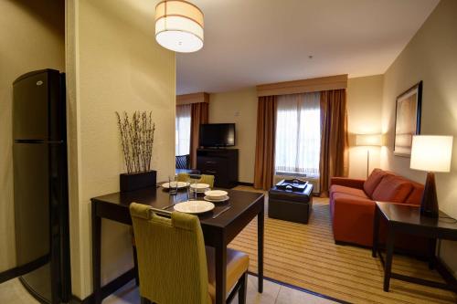 a hotel room with a dining table and a living room at Homewood Suites by Hilton Fort Worth West at Cityview in Fort Worth