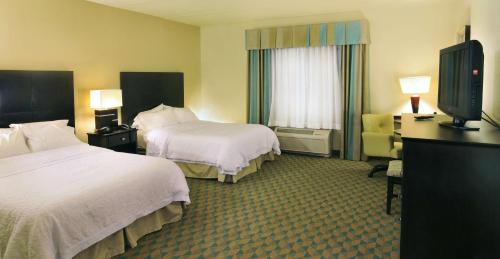 a hotel room with two beds and a flat screen tv at Hampton Inn Gadsden/Attalla Interstate 59 in Gadsden