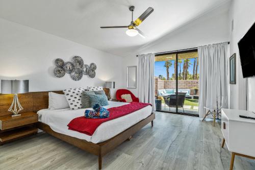 a bedroom with a bed and a large window at North De Anza Manor Permit# 615 in Palm Springs