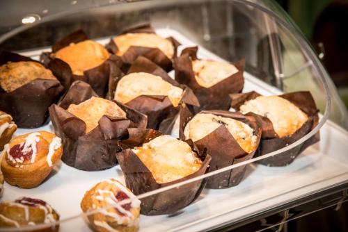 a display case filled with chocolate and other pastries at Hampton Inn & Suites Gulfport in Gulfport