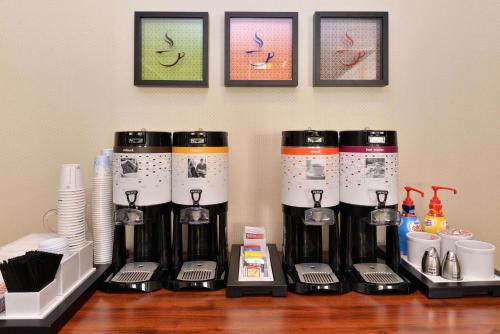 a group of coffee machines sitting on a table at Hampton Inn Grand Island in Grand Island