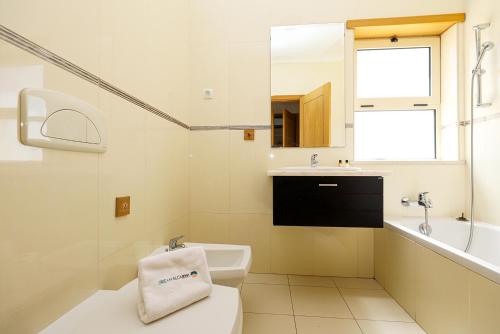 a bathroom with a toilet and a sink and a mirror at C07 - 3 Bed Luxury Penthouse in Downtown Lagos in Lagos