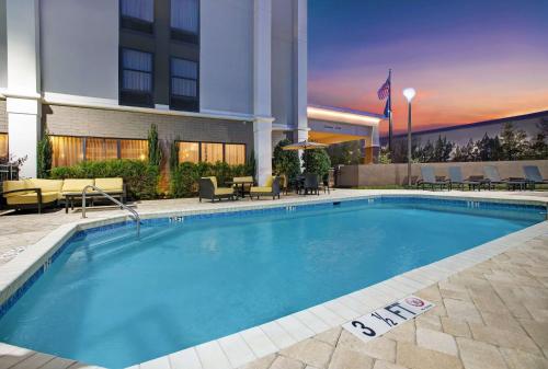 a large swimming pool in front of a hotel at Hampton Inn Greenville/Woodruff Road in Greenville
