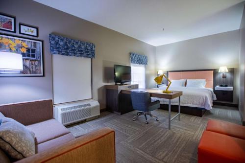a hotel room with a bed and a desk at Hampton Inn Hadley-Amherst Area in Hadley