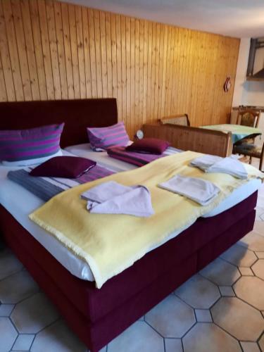 a large bed with towels on top of it at Pension Barghus GmbH in Zinnowitz