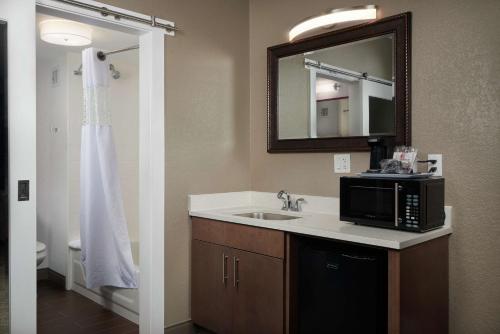 a bathroom with a sink and a microwave at Hampton Inn Hanover in Hanover