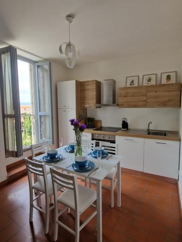 a kitchen with a table and some chairs and a kitchen with a table at Hotel Porta Marmorea in Gubbio