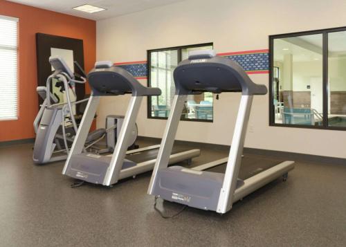 three tread machines in a gym with mirrors at Hampton Inn Hickory in Hickory