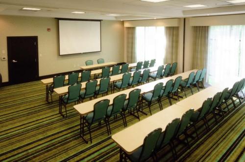 a conference room with tables and chairs and a screen at Hampton Inn Hickory in Hickory