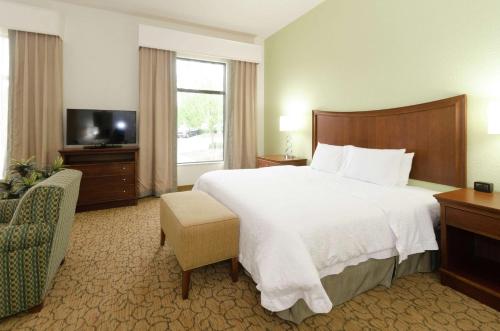 a hotel room with a large bed and a television at Hampton Inn Hickory in Hickory