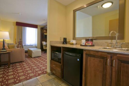 a kitchen with a sink and a large mirror at Hampton Inn & Suites Wiggins in Wiggins