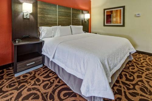 a large white bed in a hotel room at Hampton Inn Houston Baytown in Baytown