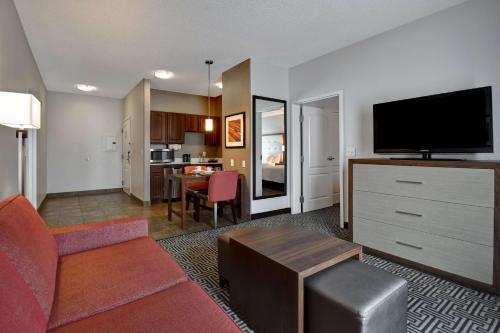 a living room with a couch and a flat screen tv at Homewood Suites By Hilton HOU Intercontinental Airport in Houston
