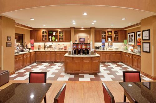 a large kitchen with wooden cabinets and a counter at Hampton Inn & Suites by Hilton Hemet Menifee Murrieta in Hemet