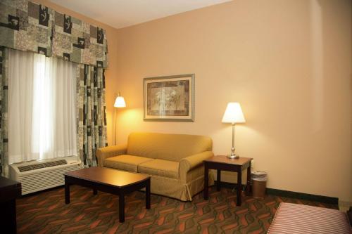 a living room with a couch and a window at Hampton Inn & Suites Houston Rosenberg in Rosenberg