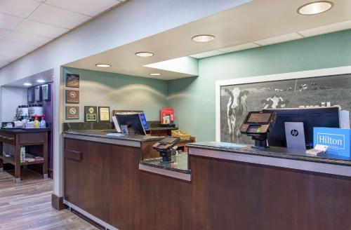a cashiers counter in a store with a cash register at Hampton Inn Cullman in Cullman