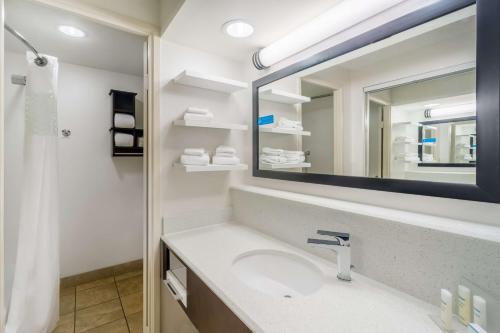 a bathroom with a sink and a mirror at Hampton Inn Terre Haute in Terre Haute