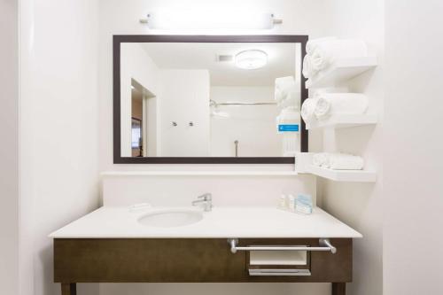 a bathroom with a sink and a mirror at Hampton Inn Havelock in Havelock