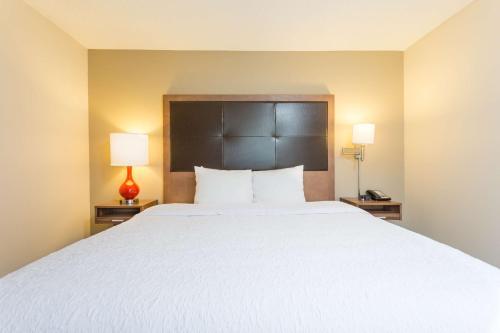 a bedroom with a large white bed with two lamps at Hampton Inn Havelock in Havelock