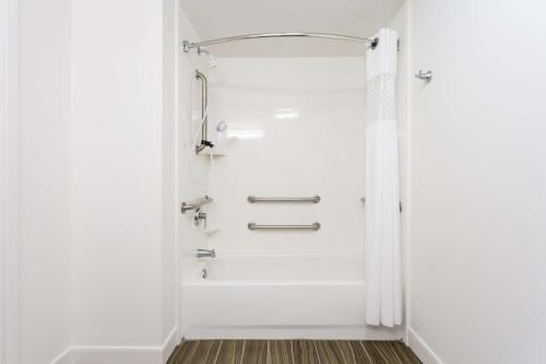 a shower in a bathroom with a shower curtain at Hampton Inn Havelock in Havelock