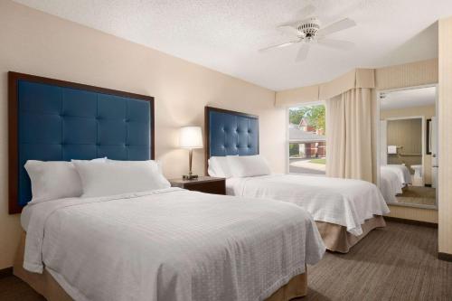 a hotel room with two beds and a window at Homewood Suites by Hilton Wilmington-Brandywine Valley in Talleyville
