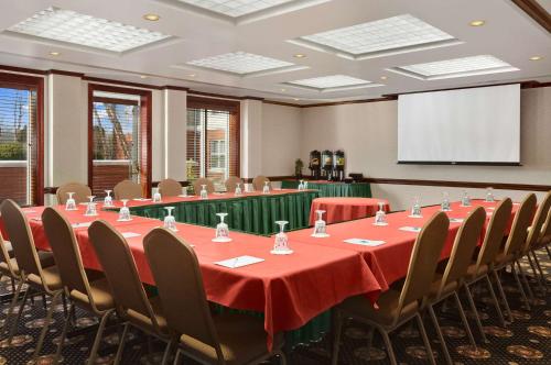 a conference room with a table and chairs and a screen at Homewood Suites by Hilton Wilmington-Brandywine Valley in Talleyville